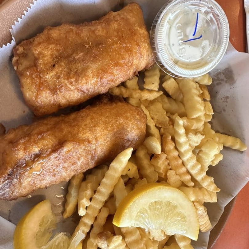 Side Street Diner's fish and chips with two lemon wedges and a side of tartar sauce.