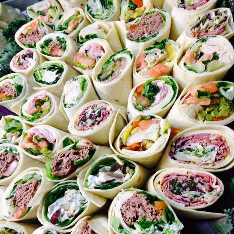 Assortment of Side Street Diner wraps with various fillings like tuna salad, ham, and roast beef.